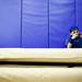 Twelve-year-old Ben Kunec plays a video game while his brother plays in the Pioneer junior varsity game on Friday, Jan. 18. Daniel Brenner I AnnArbor.com